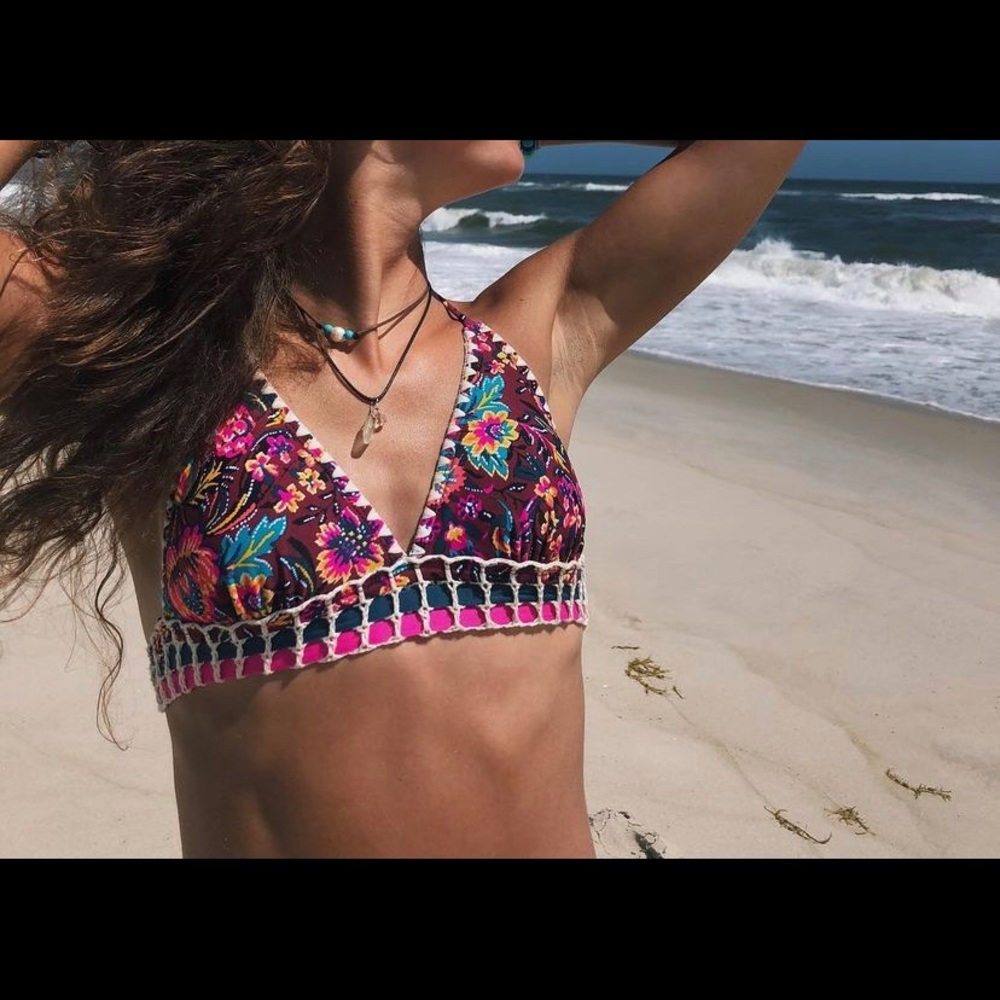 Colorful patterned target bathing suit top.